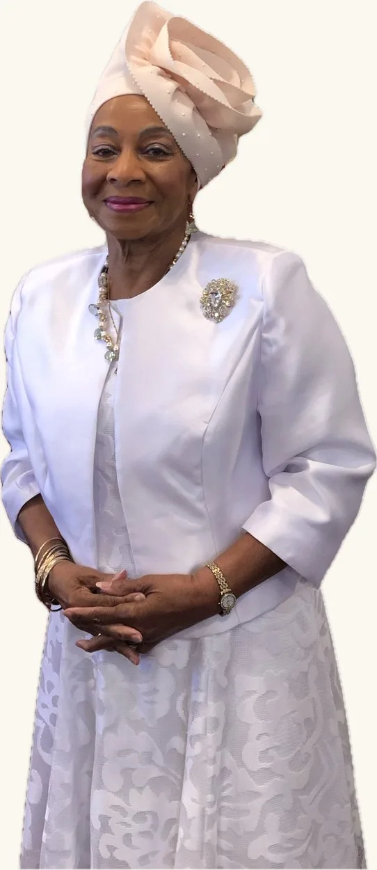 Missionary Katherine Cash Griffey dressed in white with a blush headwrap and a jewelled brooch.